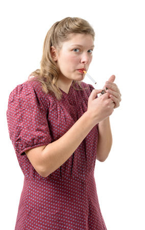 pretty young woman with clothes 1940 smoke a cigaretteの写真素材