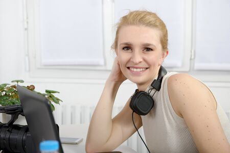 beautiful smiling blonde happy woman  with headphonesの写真素材