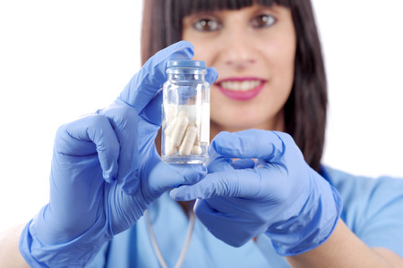 woman doctor with pills in hand closeupの写真素材