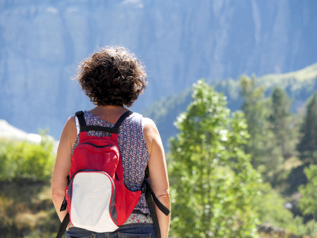 A woman hiker and cirque de Gavarnie in the French pyrenees mountainsの写真素材