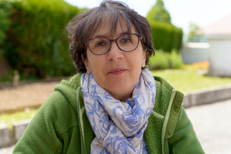 Portrait of a mature brunette woman with eyeglasses in gardenの写真素材
