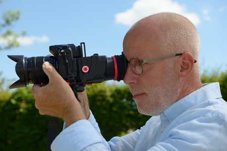 A mature man using a camera  dslr