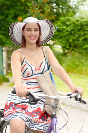 a young attractive woman riding a bicycleの写真素材