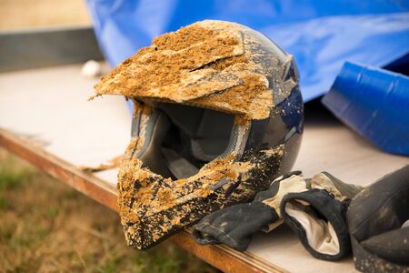 a dirty motorcycle motocross helmet with mudの写真素材
