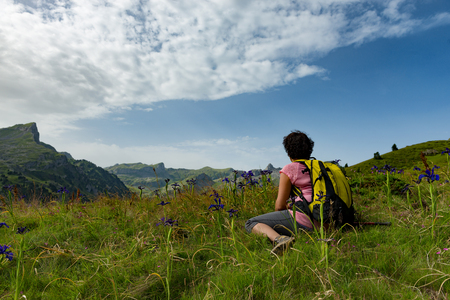 a hiker woman resting in the mountainの写真素材