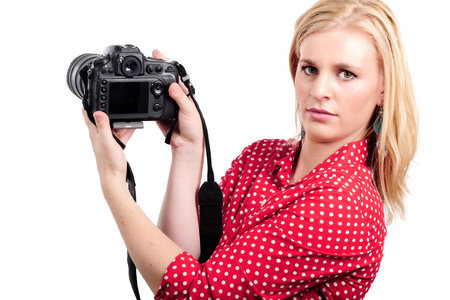 a pretty blonde woman photographer with her camera, on whiteの写真素材