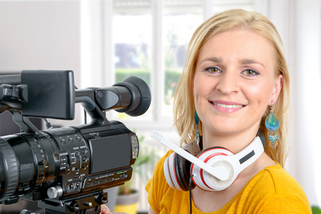 a blond young woman with professional video camera