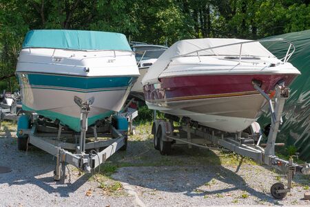 two motor boats on trailers in parkingの写真素材