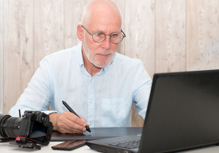 mature man working on his graphics tablet