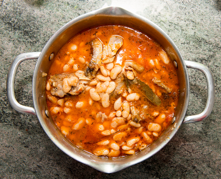 sheep stew with white beans in a saucepanの写真素材