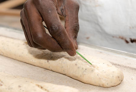 the baker prepares bread dough, french baguettes