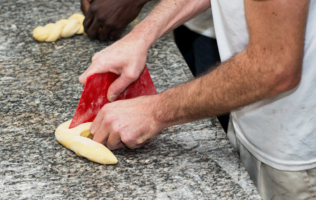 the baker prepares a  bread dough