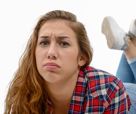 a beautiful young woman with an expression of sadnessの写真素材