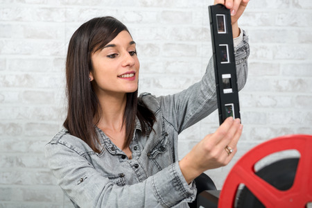 a young woman photographer looking at film slideの写真素材