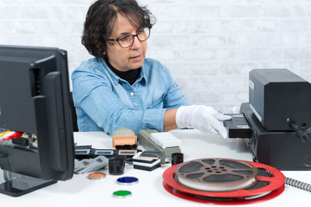 technician woman with a VHS cassette for digitization