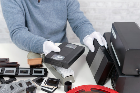 a technician man with cassette for digitizationの写真素材