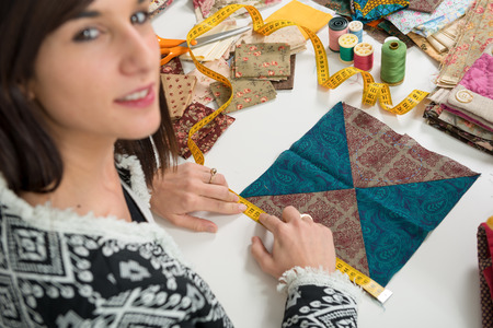 a portrait of a young seamstress in her studioの写真素材