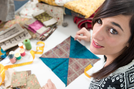 a portrait of a young seamstress in her studio