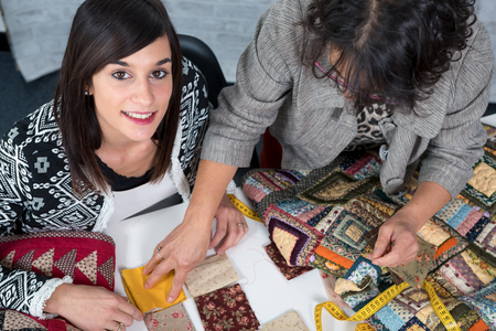 a seamstress and her apprentice with fabric for patchwork