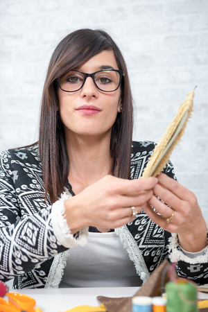 a portrait of a young seamstress in her studioの写真素材