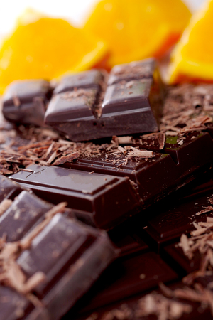 tablet and some pieces of dark chocolate の写真素材