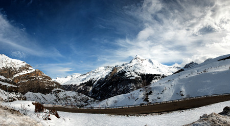 snowy Pyrenees mountains with a small roadの写真素材