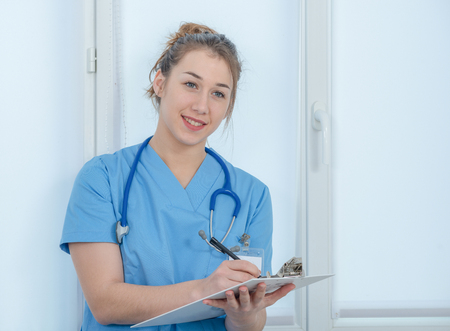 portrait of a young nurse in blue uniformの写真素材