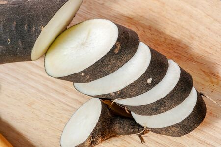 black radish cut in slice on a wooden boardの写真素材