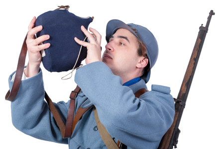 1918 French soldier drinking in his gourd, isolated on white