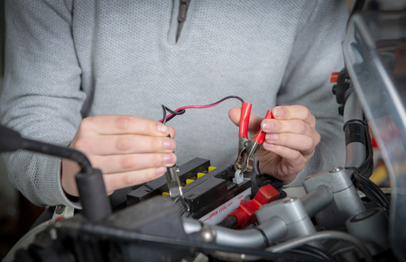 charging the battery of a  motorcycleの写真素材