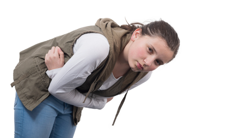 teenage girl with a stomach ache isolated  on white backgroundの写真素材