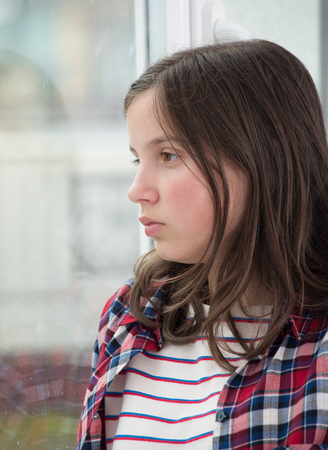 portrait of a smiling young teenage girl with check shirtの写真素材