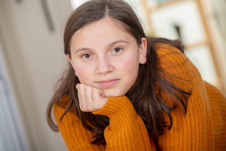 a young teenage girl with an yellow sweaterの写真素材