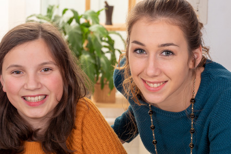 a portrait of pretty beautiful charming  adorable with long hair girl and her older friendの写真素材