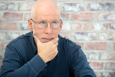 portrait of a senior man with a beard and glasses