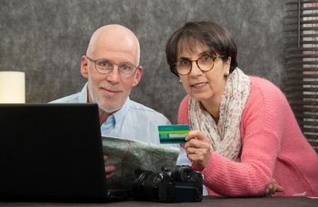 a senior couple making online purchases at home