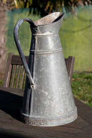 an antique zinc metal pitcher, outdoorsの写真素材