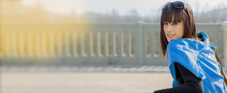 Portrait of smiling brunette young woman in blue sweaterの写真素材