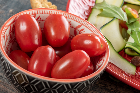 a close up of bowl of cherry tomatoesの写真素材
