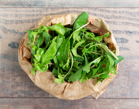Fresh organic Arugula salad in the paper bageの写真素材