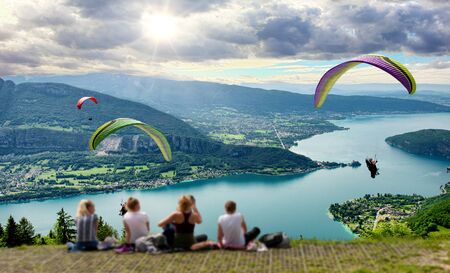 Paragliders with parapente jumping of the Col de Forclaz near Annecy in French Alps, in France.の写真素材