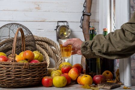 organic apples with man drinking a glass of delicious french ciderの写真素材