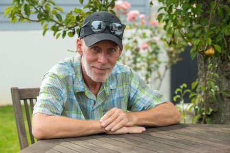a senior man in a baseball cap portrait