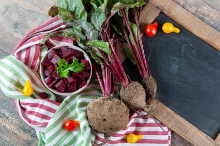 organic beetroots with black chalkboard on a wooden background