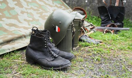 a German army helmet and boots World War II period, outdoors