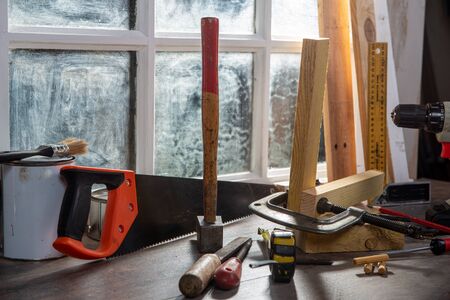 Tools of carpenter in the workshop, near the window