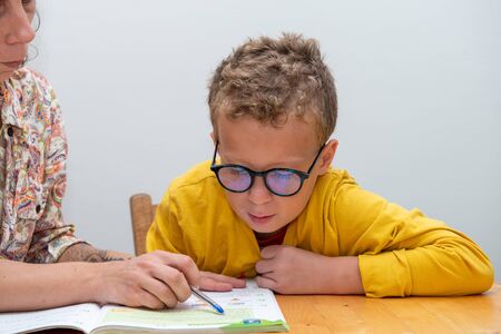 a little boy doing his homeworkの写真素材