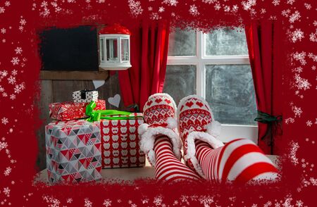 Santa woman legs with gifts. a Christmas holiday concept