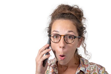 expressive businesswoman talking on the phone isolated on white backgroundの写真素材