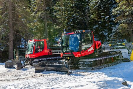 a view of two snow groomerの写真素材